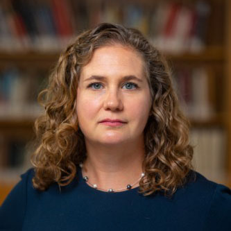 Headshot of Dr. Jennifer Nuzzo in dark blue shirt.