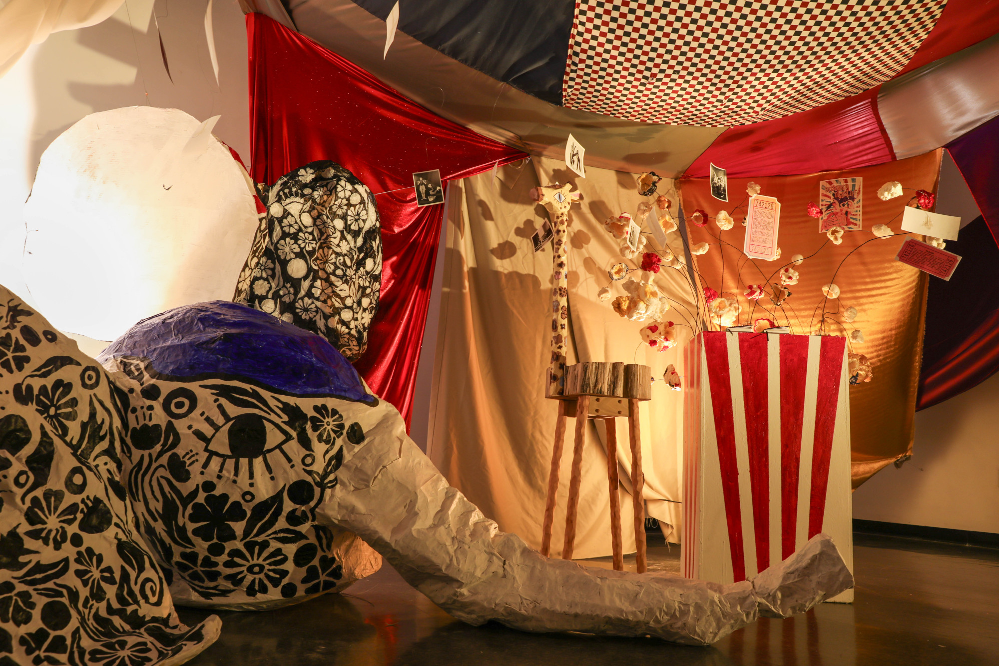 an art installation featuring a paper mache elephant head and an exploding box of popcorn