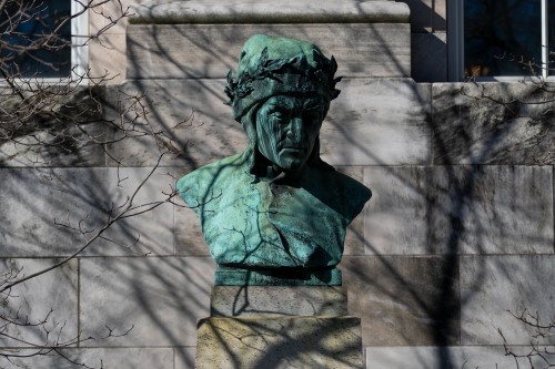 A copper statue of the bust of Dante outside of the John Hay Library