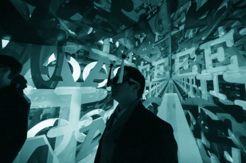 A person wearing an enhanced vision apparatus surrounded by letters.