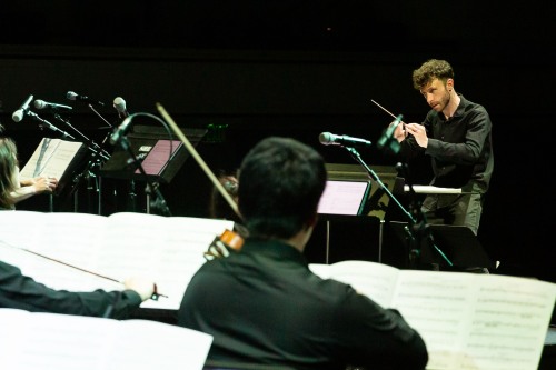 An orchestra performing on stage