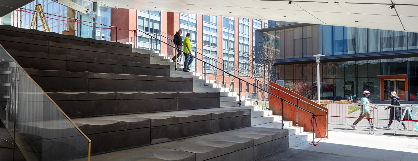 Concrete seating next to steps leading up to the Lindemann lobby.