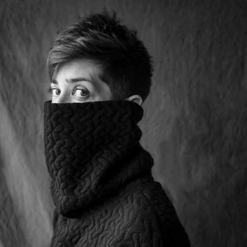 Black and white headshot of Sophia LaCava-Bohanan in a black turtle neck pulled up to her nose