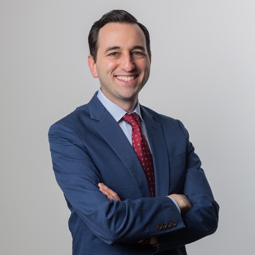 eric gershman in smiling, wearing a blue suit with arms crossed