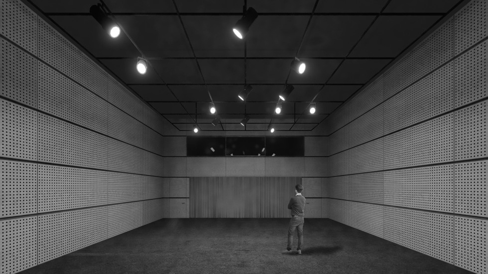 A rendering of the performance lab with a student standing facing away with arms crossed. Stage lighting from above.