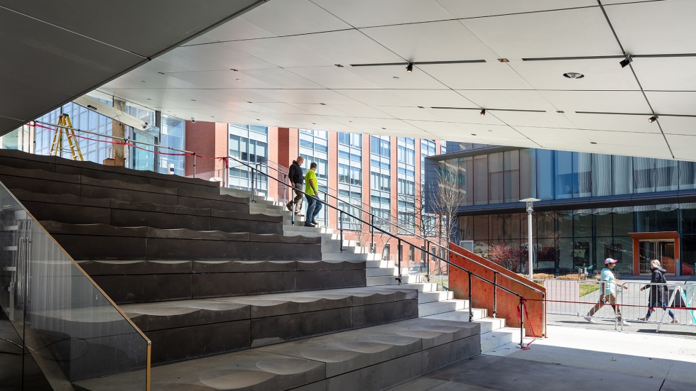 Two people walk down the stairs of The Lindemann Performing Arts Center's outdoor lobby.