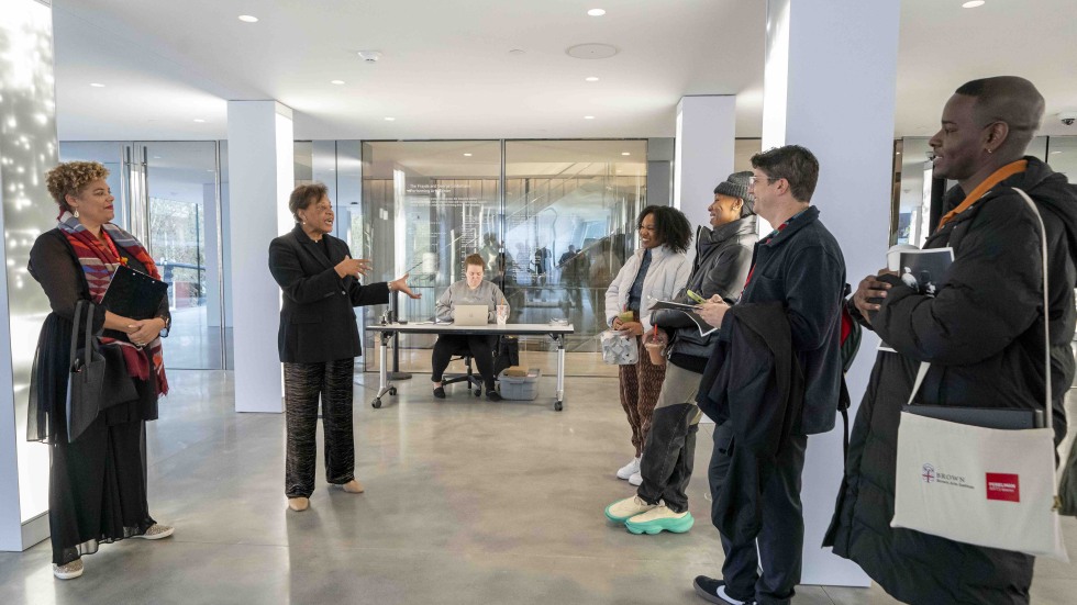 Convening participants gather with Avery Willis Hoffman and Carrie Mae Weems in lobby of The Lindemannn.