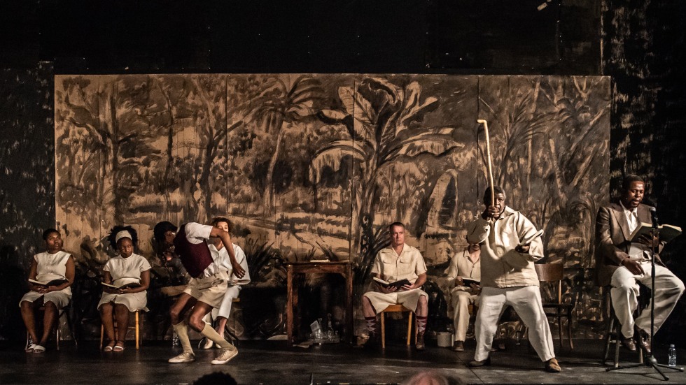 The cast of Houseboy in front of a painted backdrop.