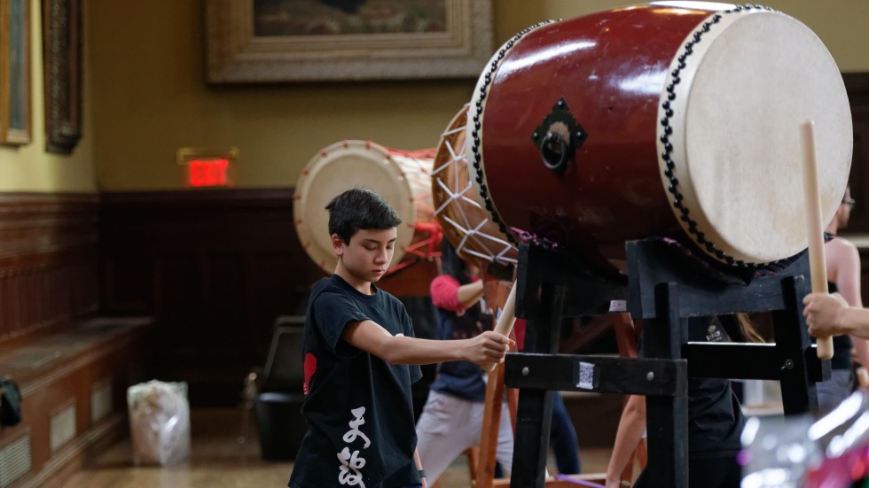 A child performs taiko drumming