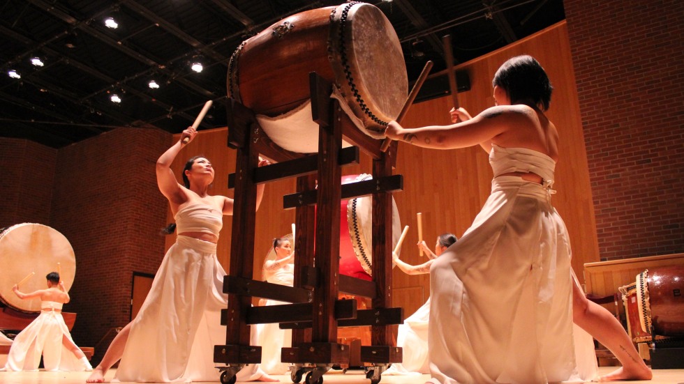 Taiko performers in white dresses