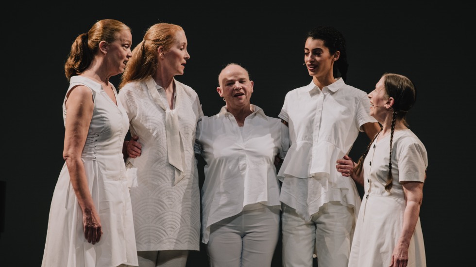 A quartet of singers wearing white.