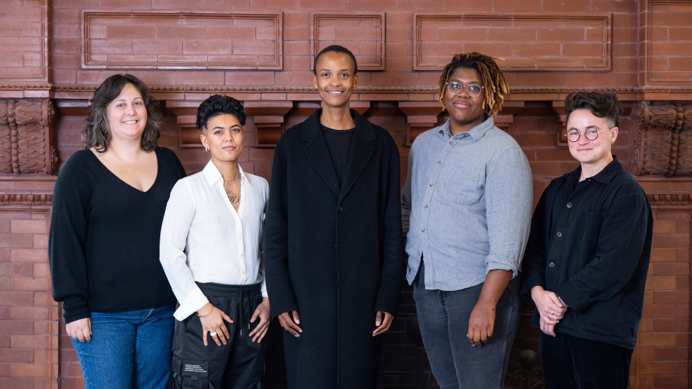 The Racial Ecologies Colective standing in front of a brick building.