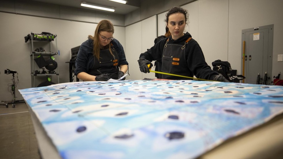 Two students work on a quilting project.