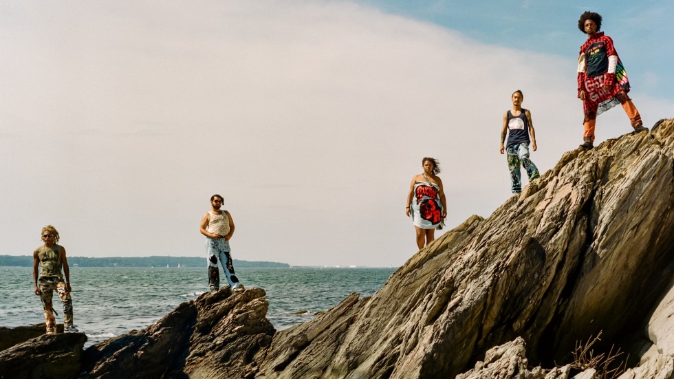 Five people standing on a rock at Beavertail State Park