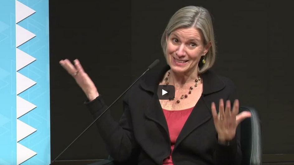 A woman on stage during a panel.